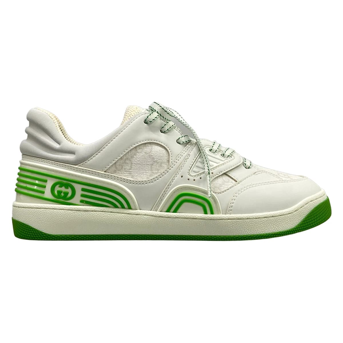 Pair of white low-top shoes with light green trim and a monogram-patterned panel.