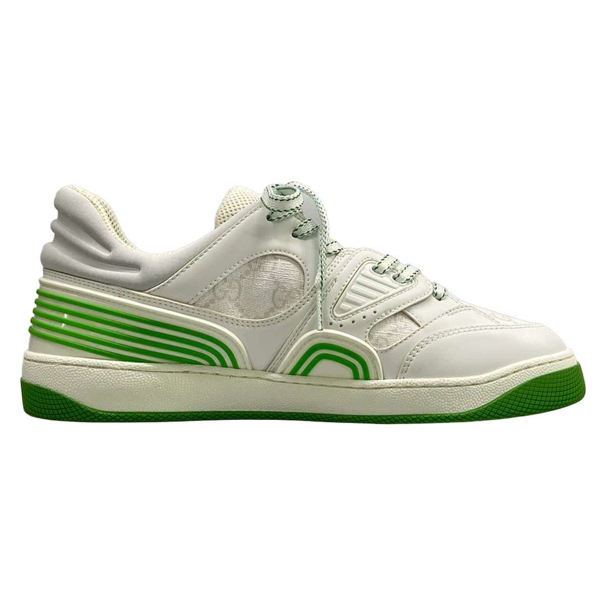 Pair of white low-top shoes with light green trim and a monogram-patterned panel.