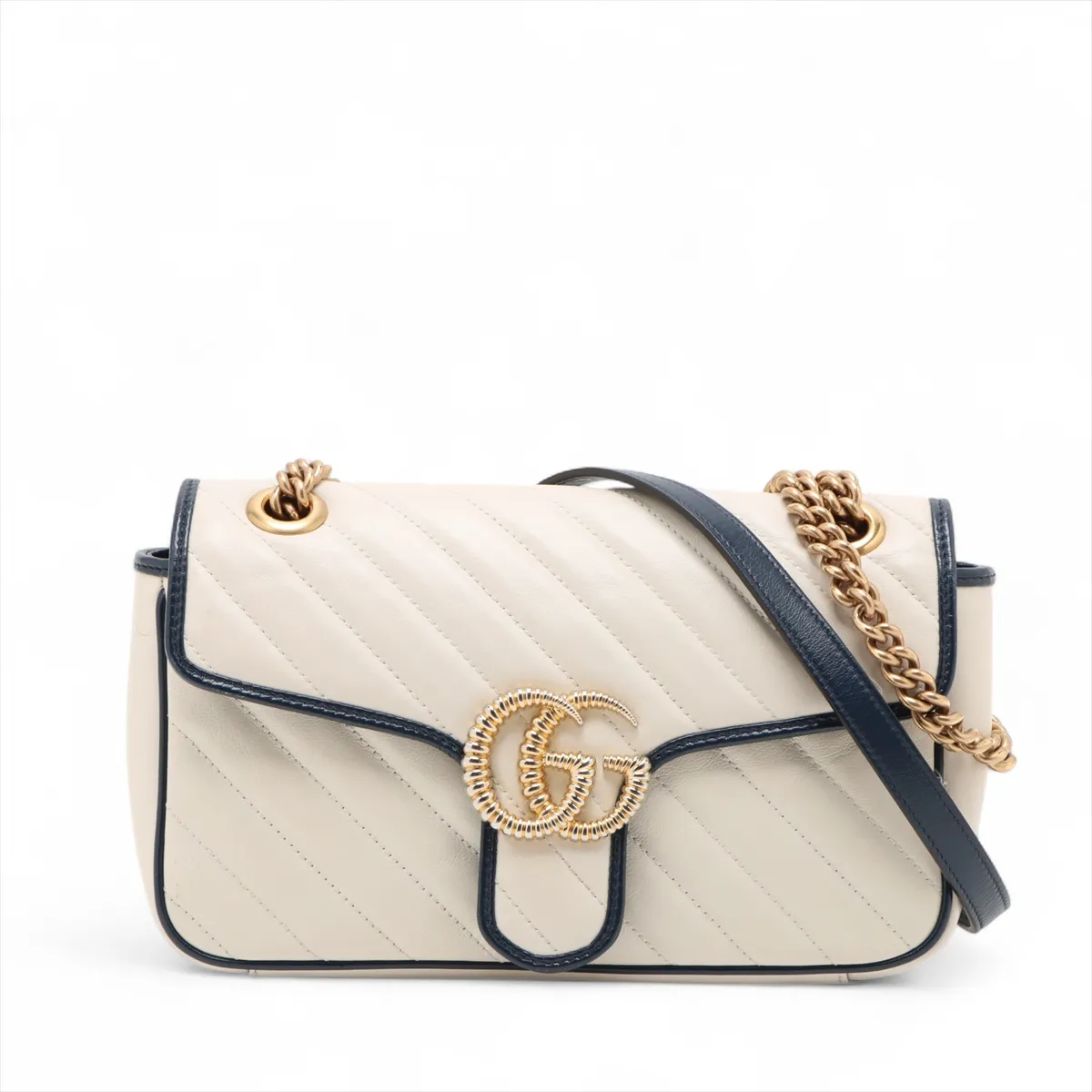 White chevron-quilted leather flap bag with navy trim, a double-G clasp and a chain strap.