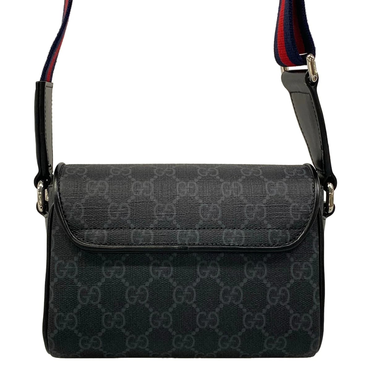 Beige and brown patterned shoulder bag with an adjustable strap.