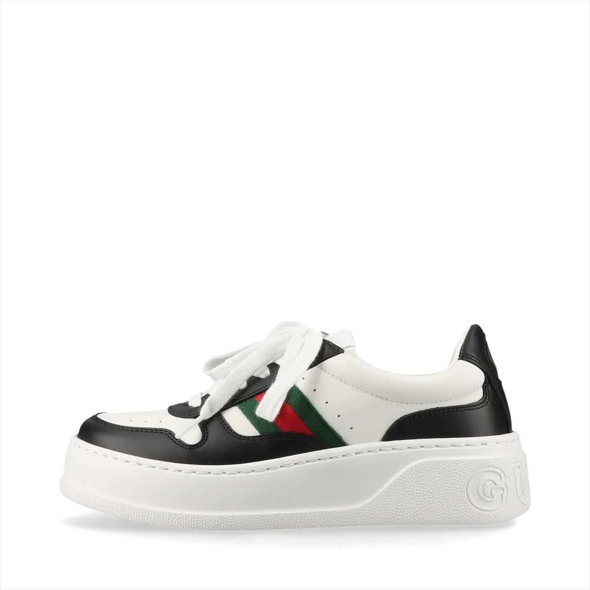Pair of black and white platform lace-up sneakers with a striped band.