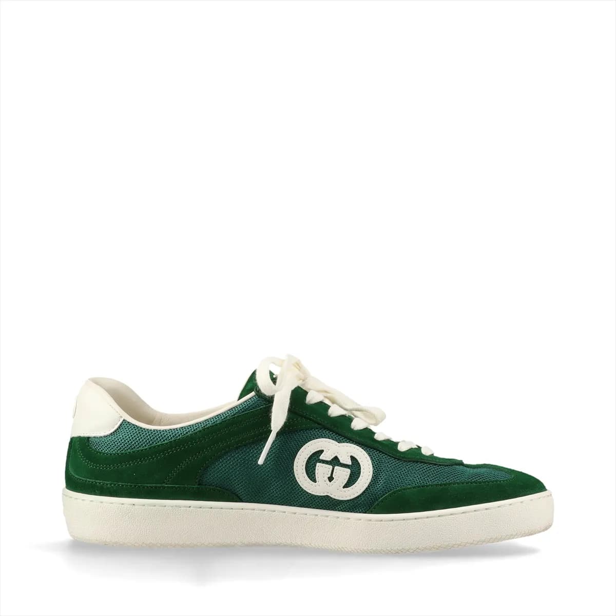 Green mesh and leather sneaker with a metal logo detail, shown in profile.