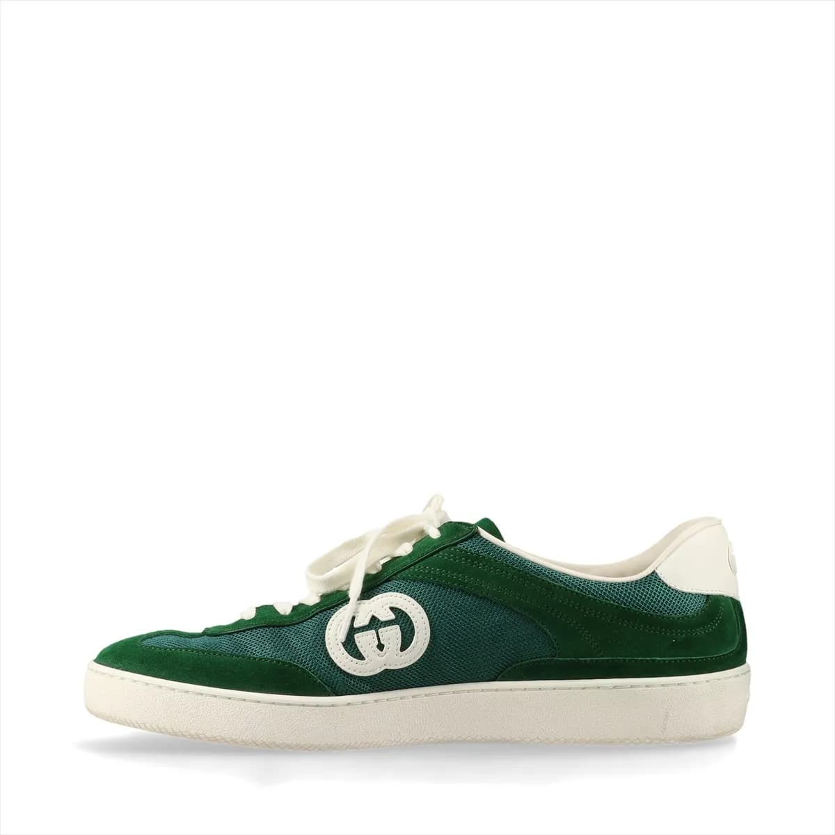 Green mesh and leather sneaker with a metal logo detail, shown in profile.