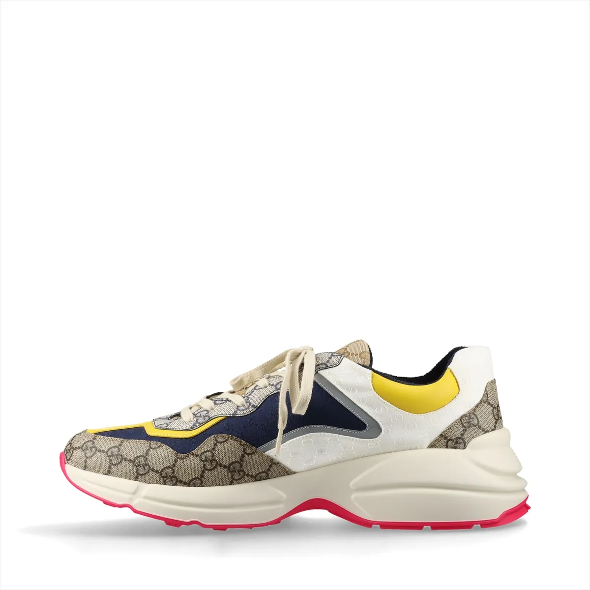 Pair of low-top multicolour patterned trainers with thick white soles, shown from the side.