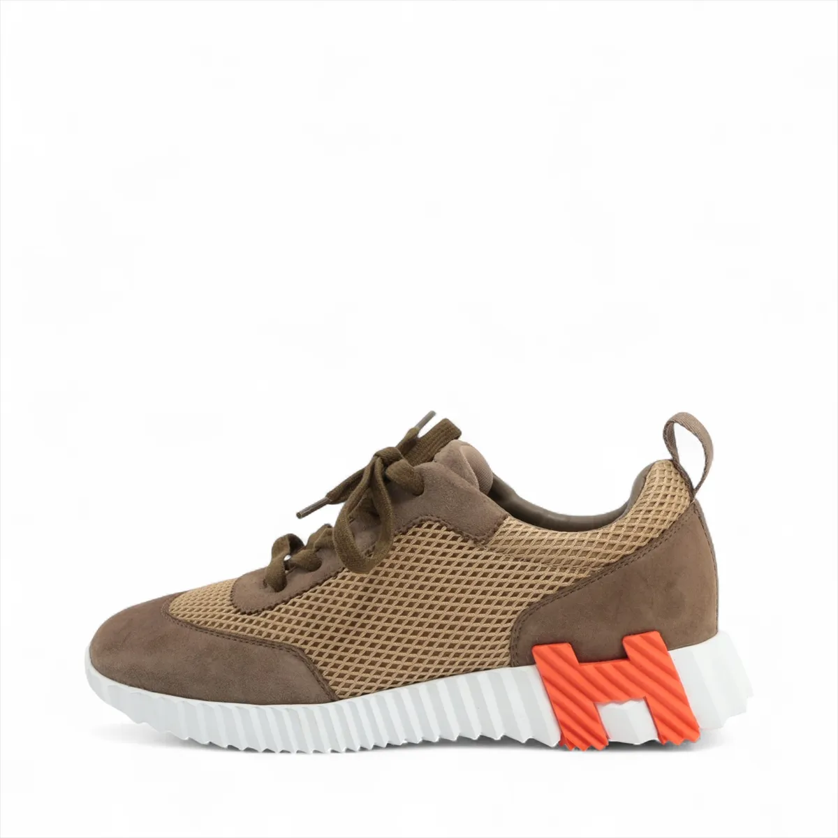 Brown suede and fabric low-top sneaker with mesh side panels and a white sole.