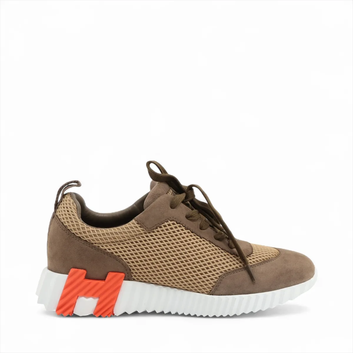Brown suede and fabric low-top sneaker with mesh side panels and a white sole.