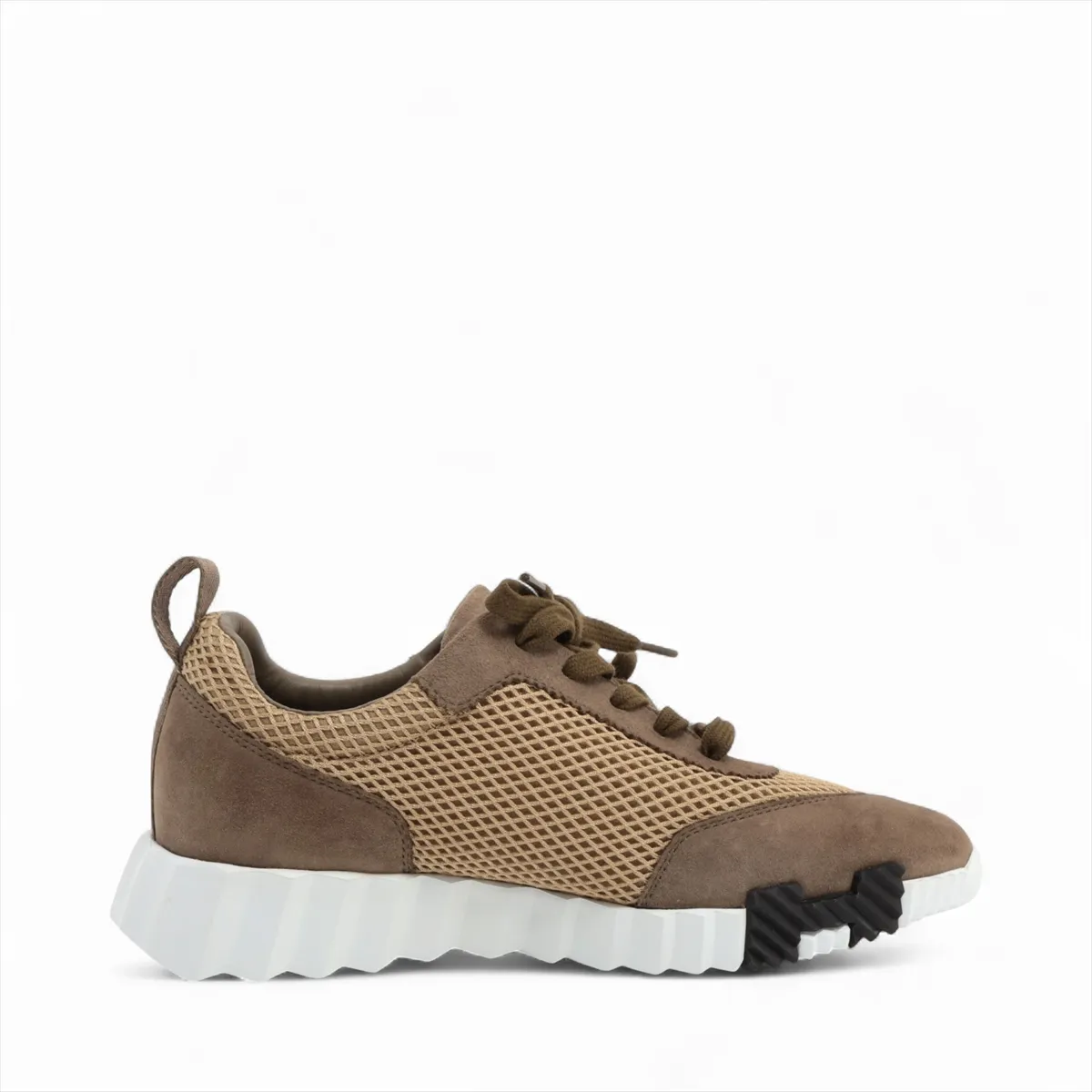 Brown suede and fabric low-top sneaker with mesh side panels and a white sole.