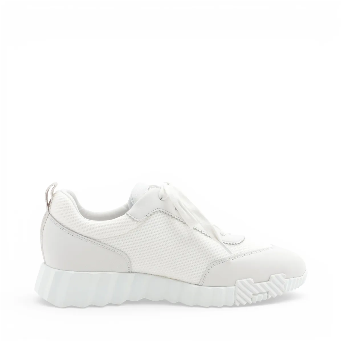 Light grey and white running-style sneakers with mesh panels and a thick white sole.