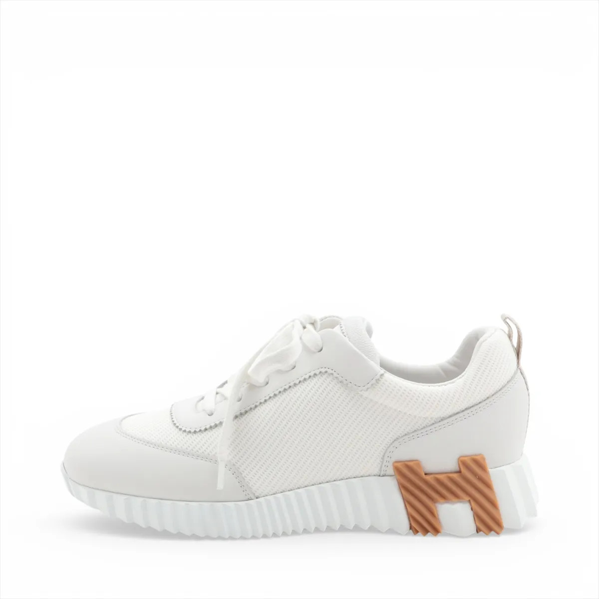 Light grey and white running-style sneakers with mesh panels and a thick white sole.