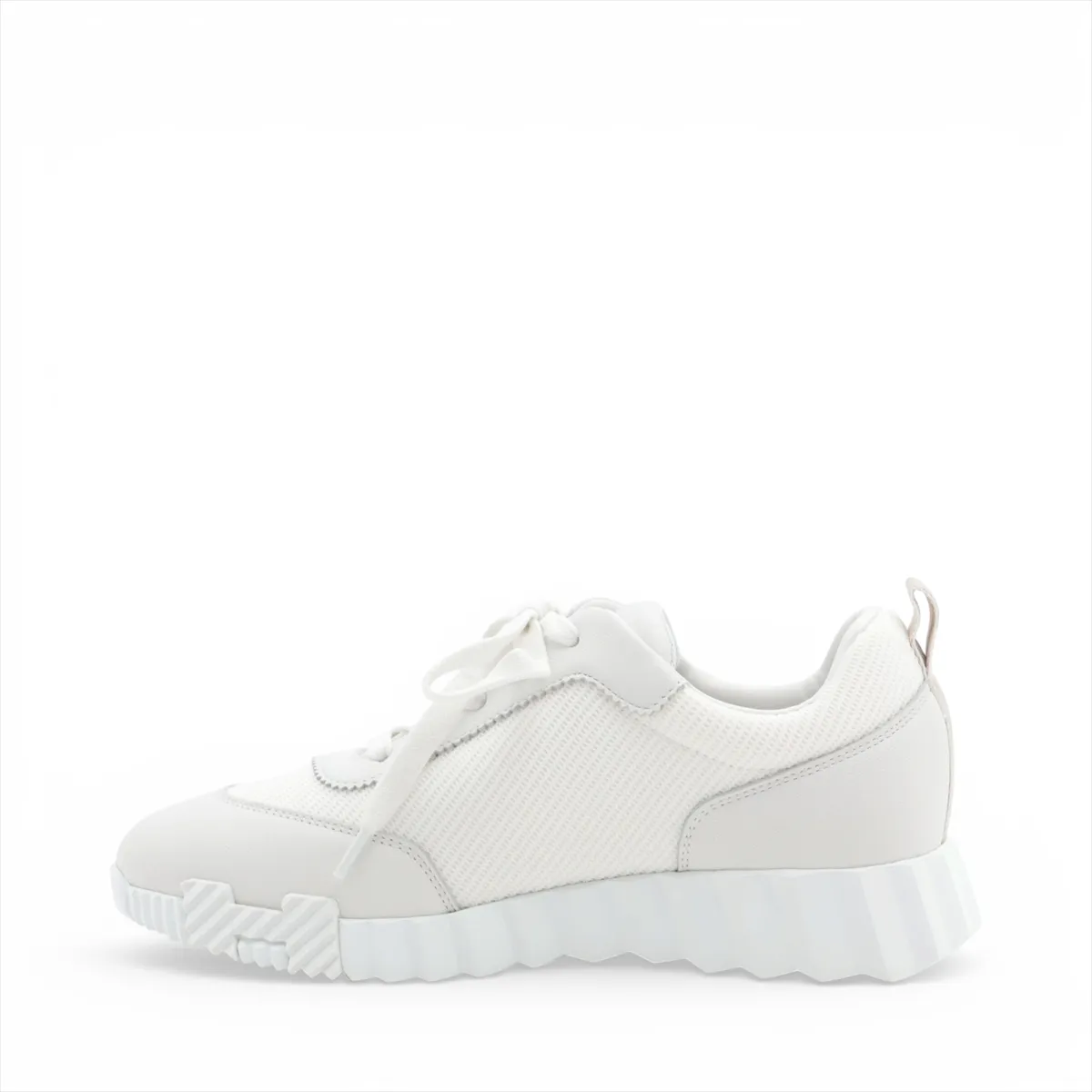 Light grey and white running-style sneakers with mesh panels and a thick white sole.