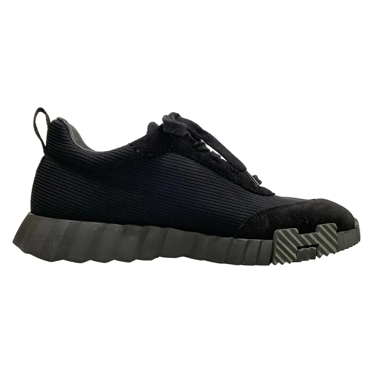 Black low-top sneakers with a white sole.