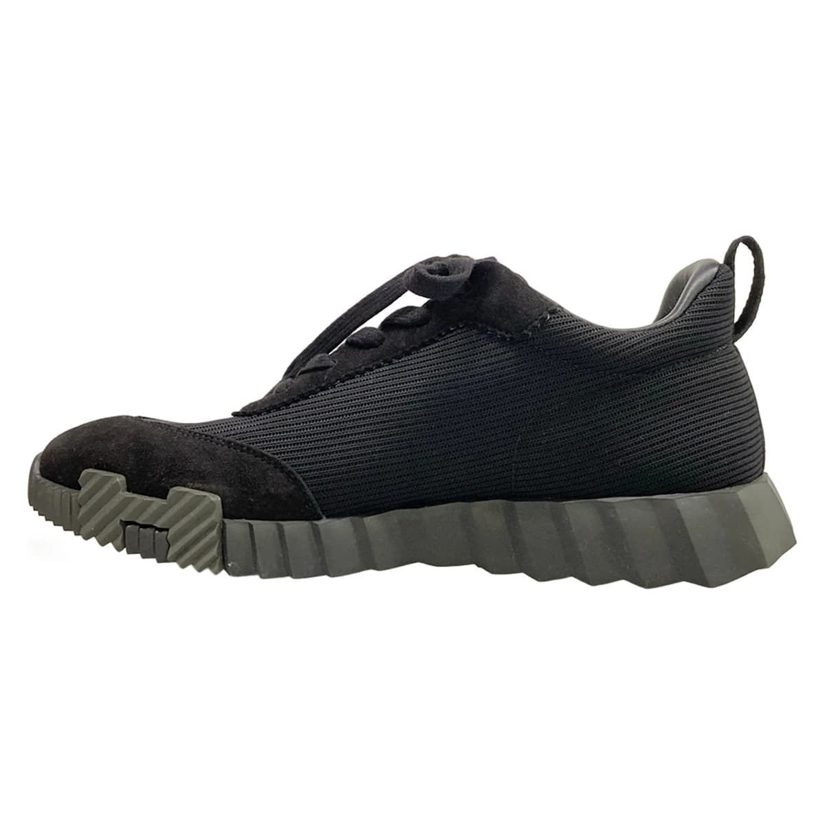 Black low-top sneakers with a white sole.