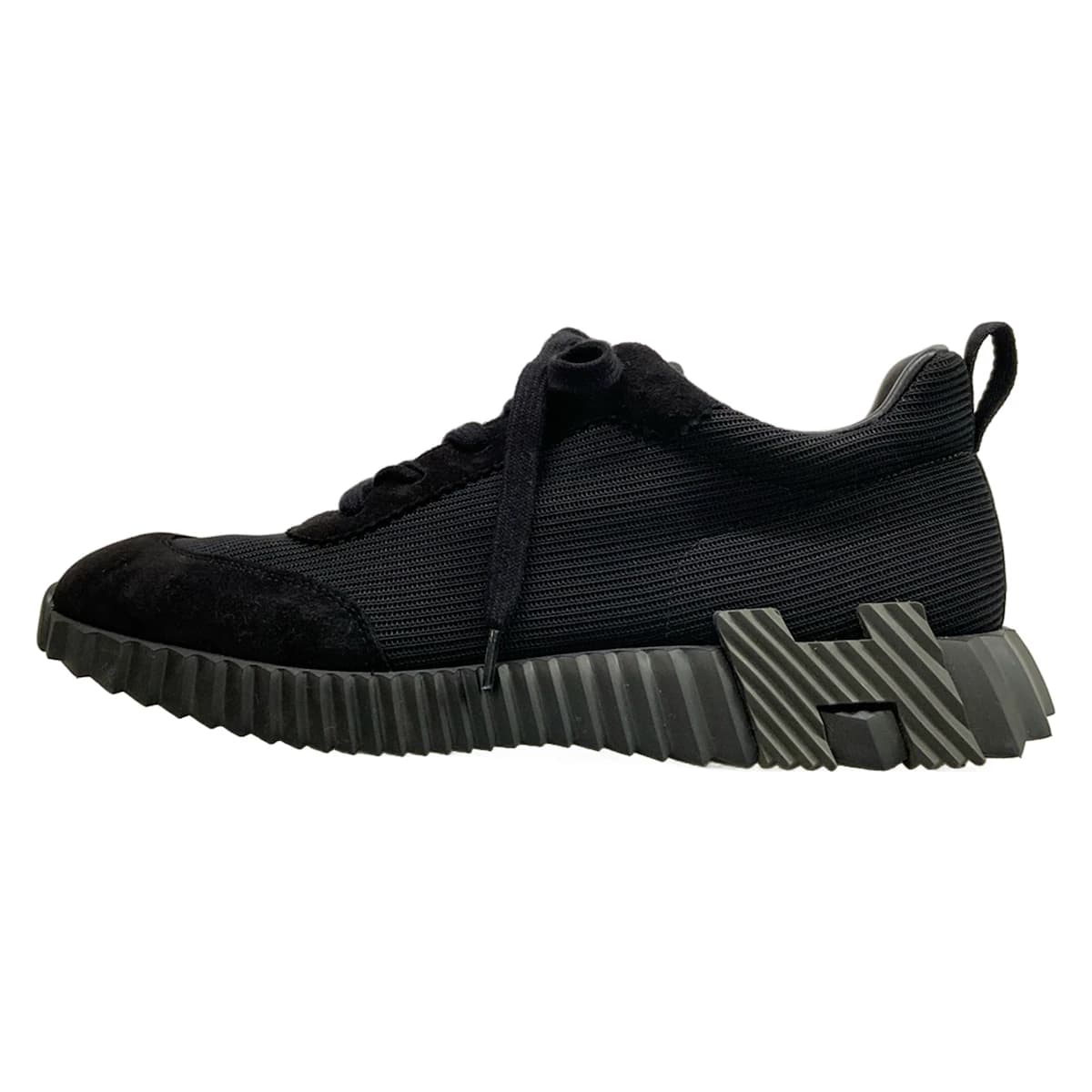 Black low-top sneakers with a white sole.
