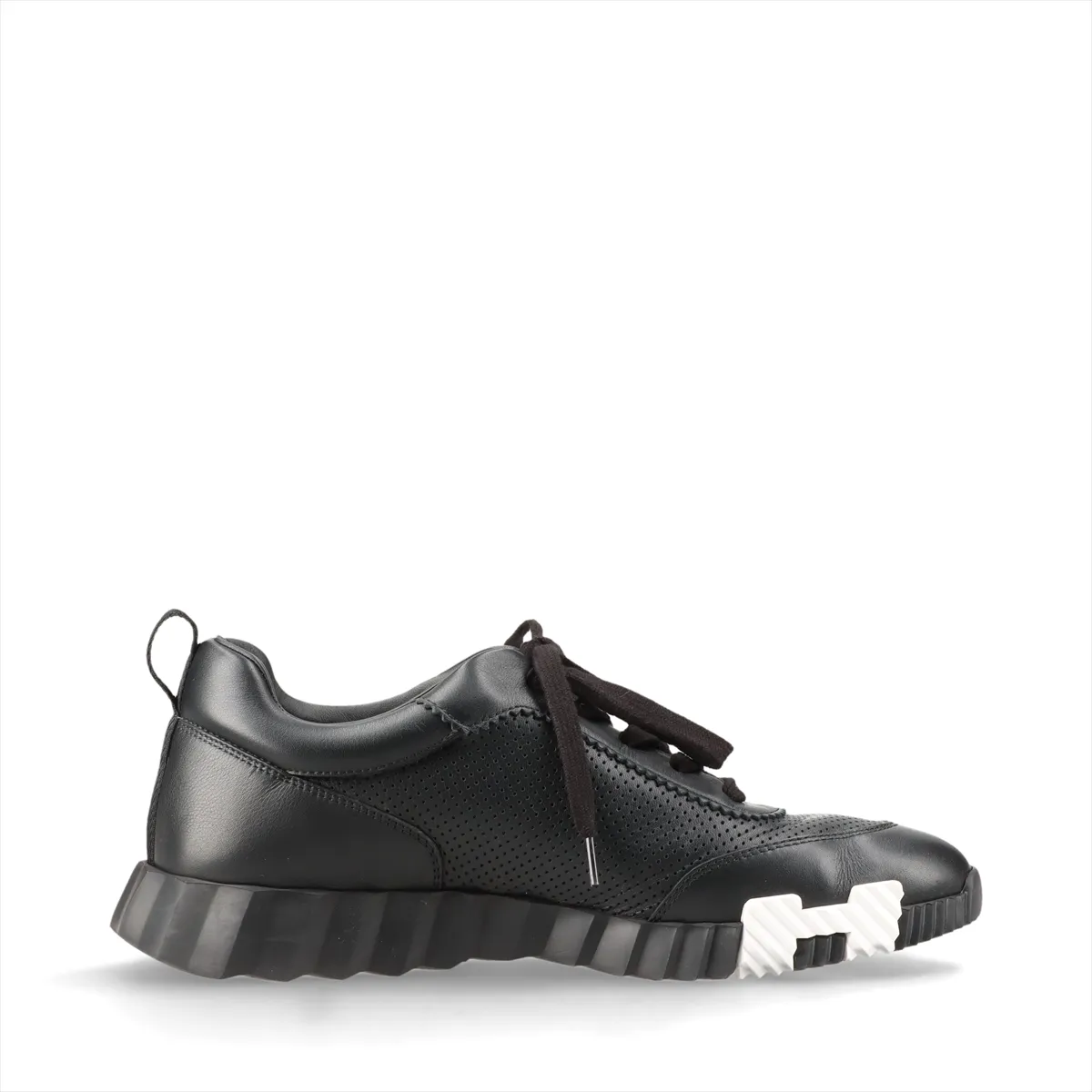 Black leather low-top sneakers with perforated panels and white soles.