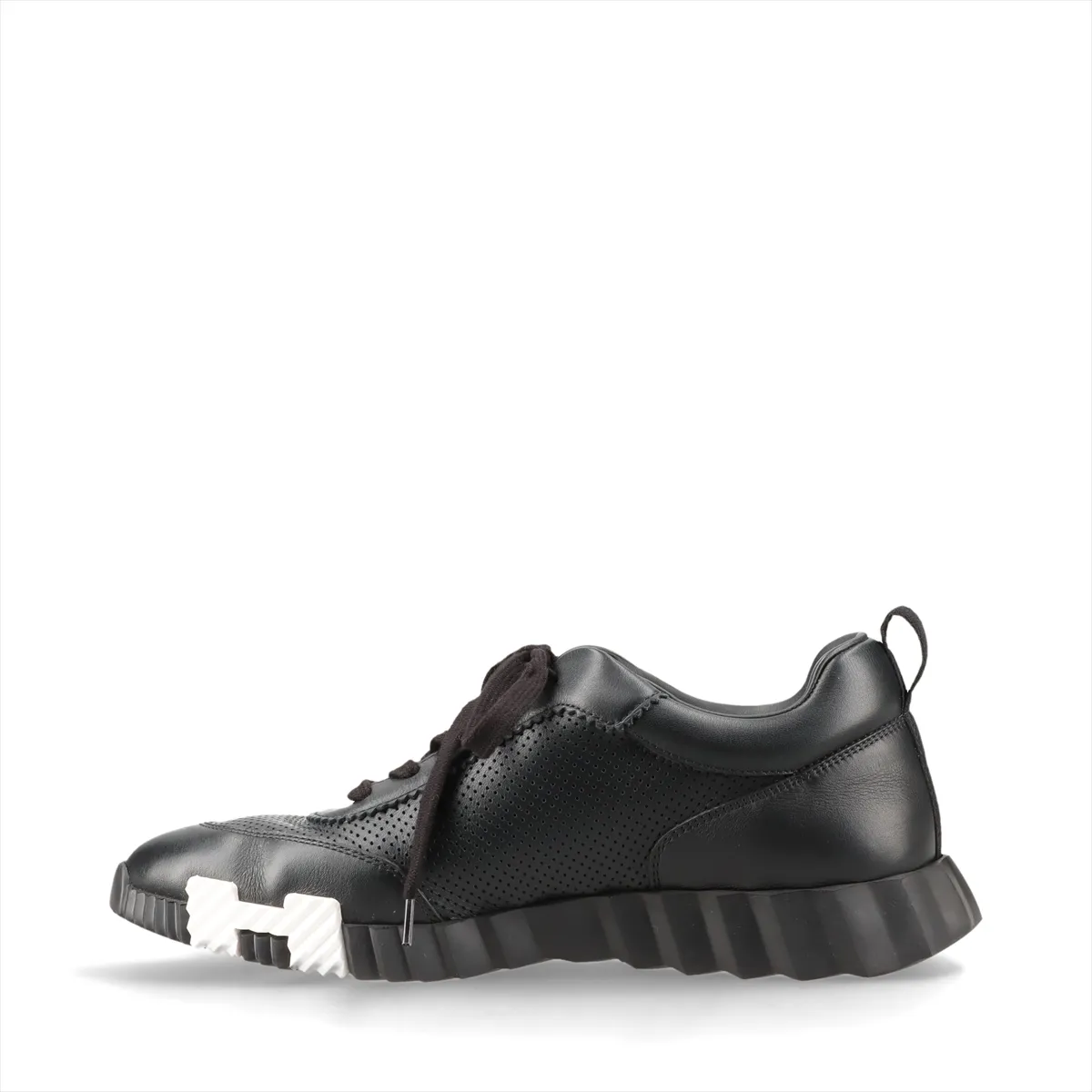 Black leather low-top sneakers with perforated panels and white soles.
