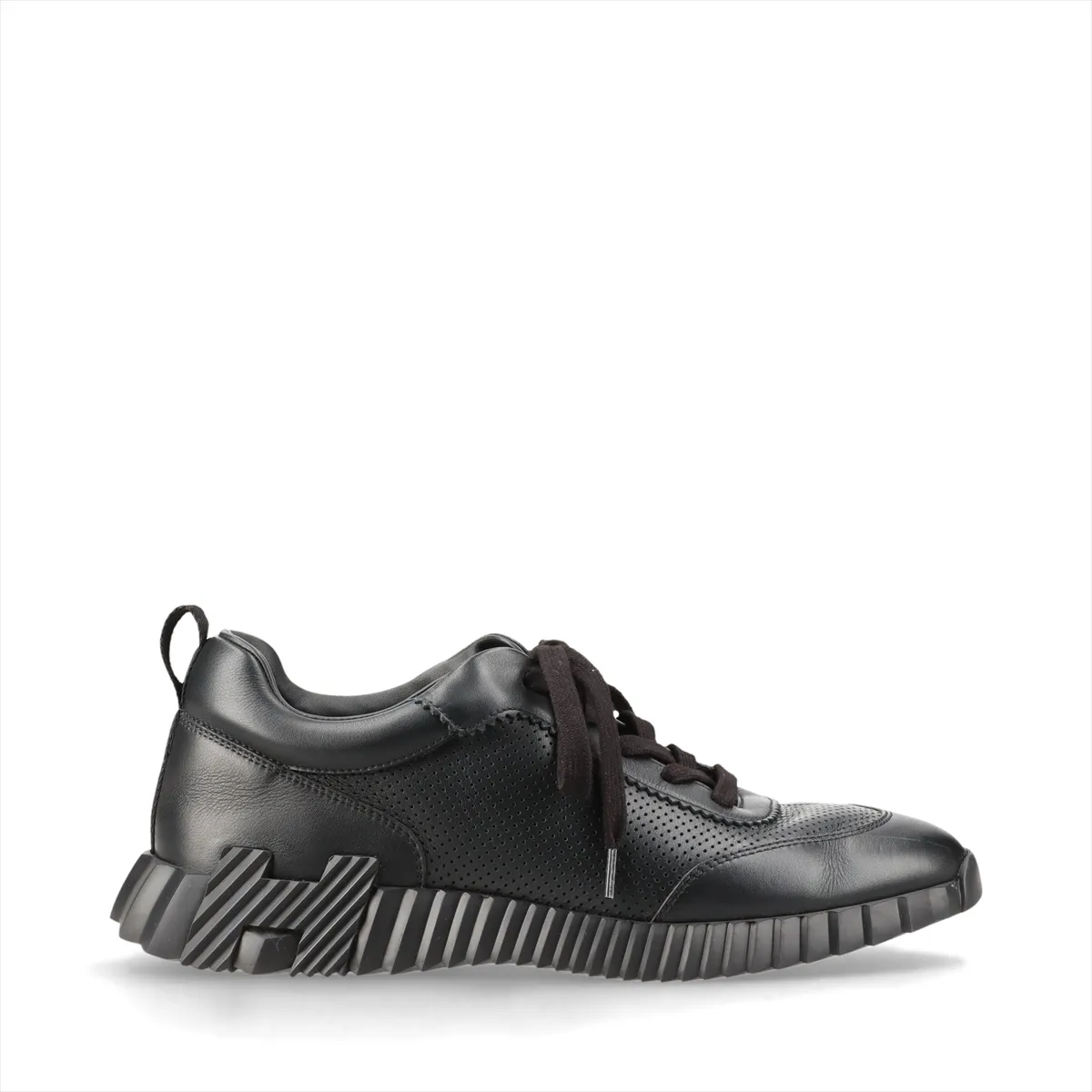 Black leather low-top sneakers with perforated panels and white soles.