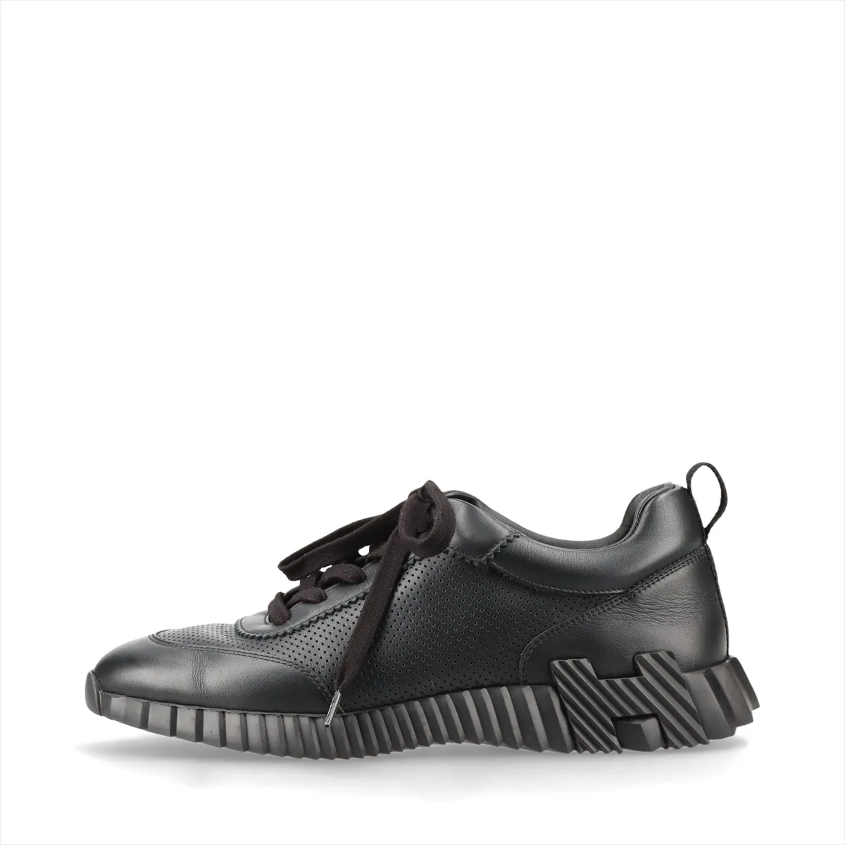 Black leather low-top sneakers with perforated panels and white soles.