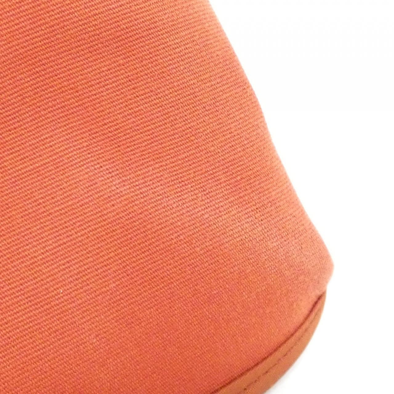 Canvas and leather bag shown upright against a plain background.