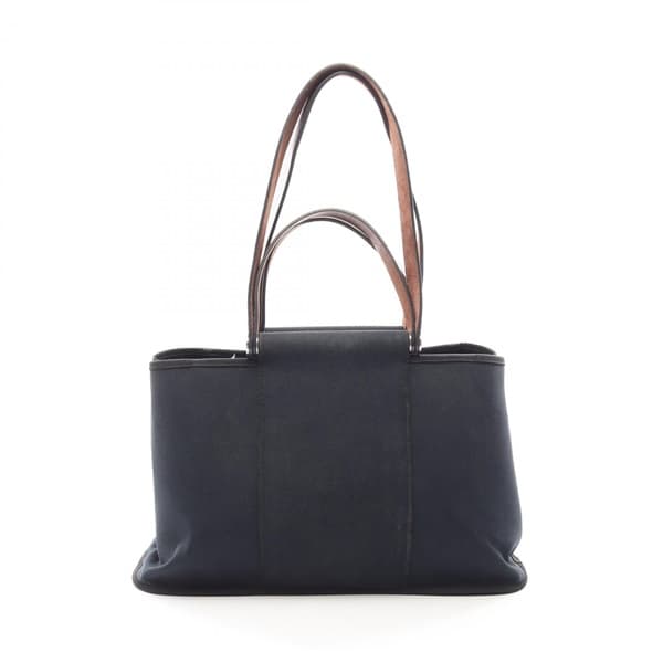 Black canvas tote bag with leather-trimmed handles and a detachable strap.