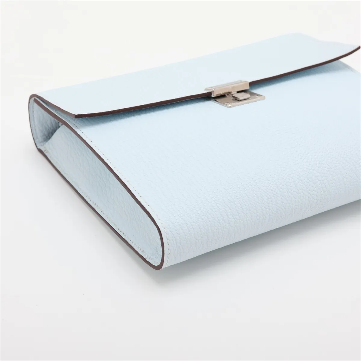 Blue grained leather piece with silver-tone metal fittings.