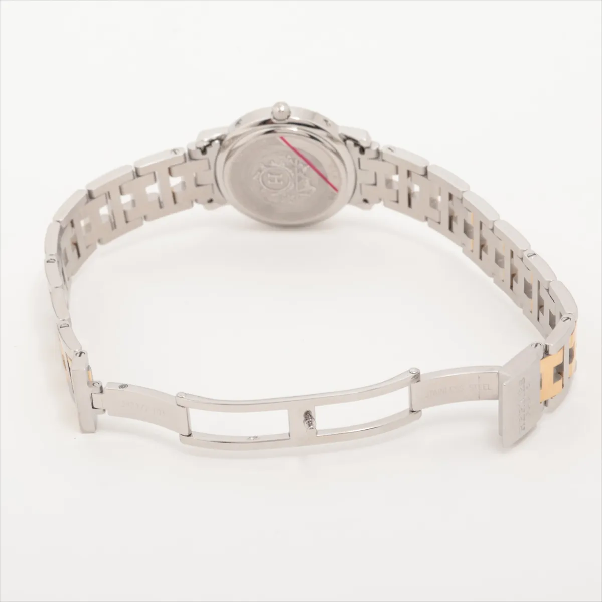 Small round two-tone watch with white dial, black numerals, date window and link bracelet.
