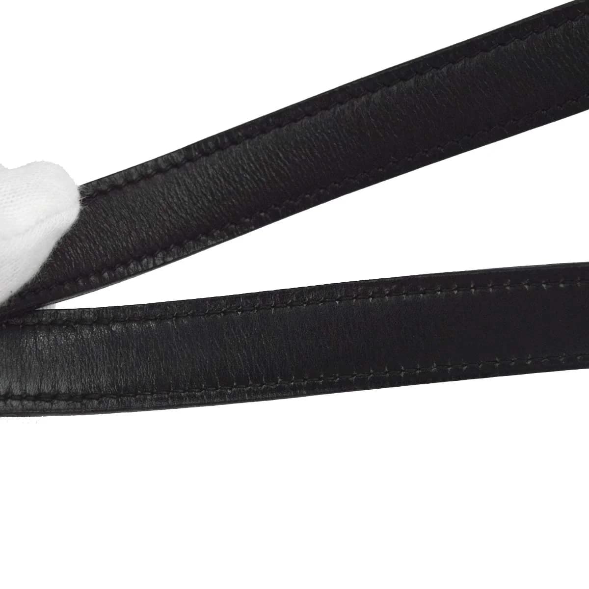 Black smooth leather shoulder bag with a flap front and a long strap