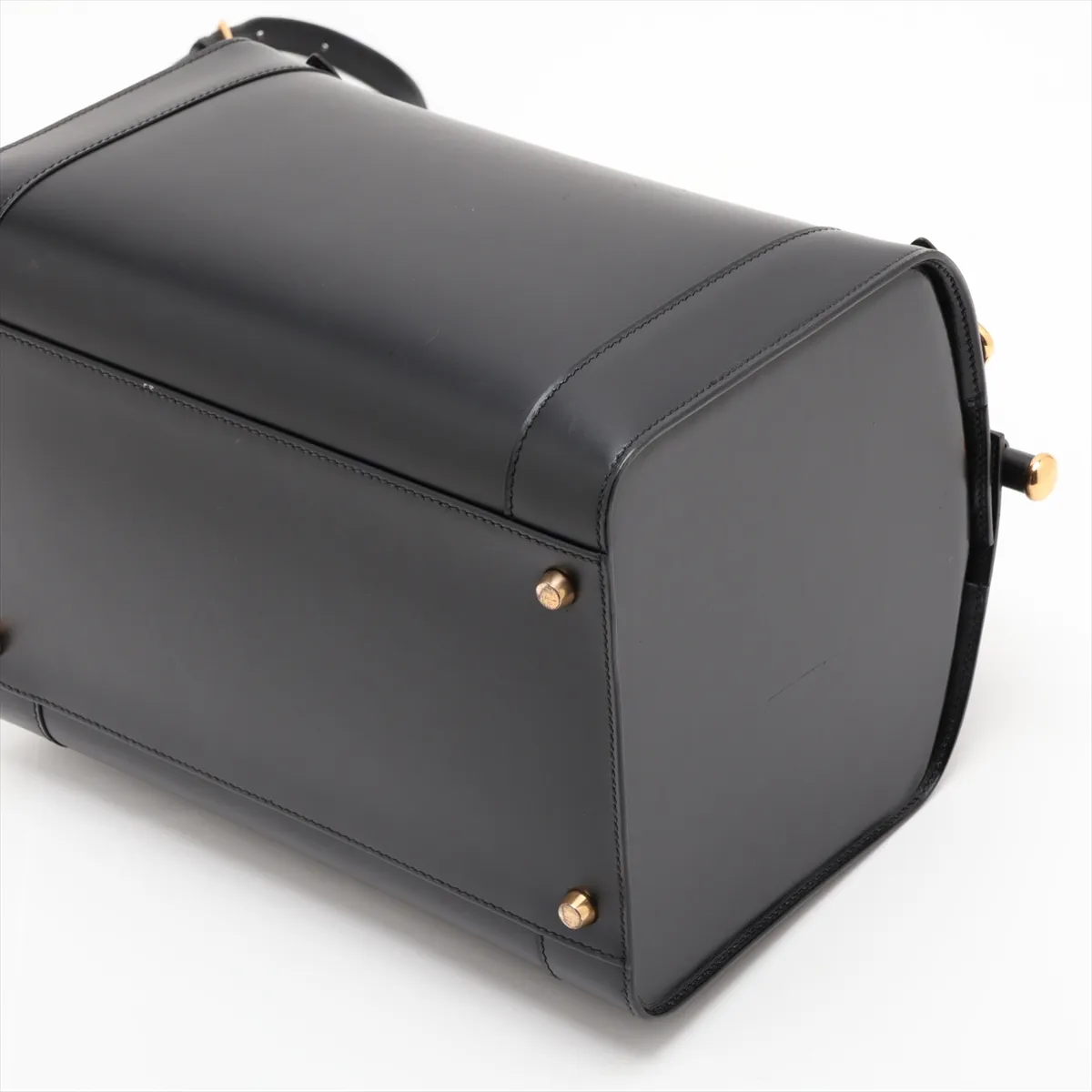 Black smooth leather bag with gold-tone fittings and a shoulder strap.