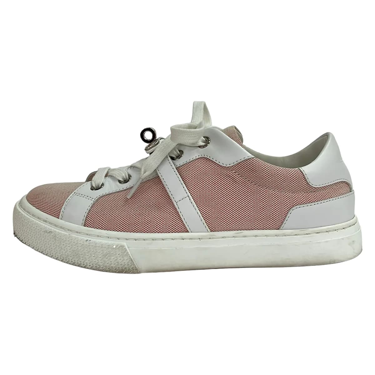 White leather low-top sneakers with red trim detailing.