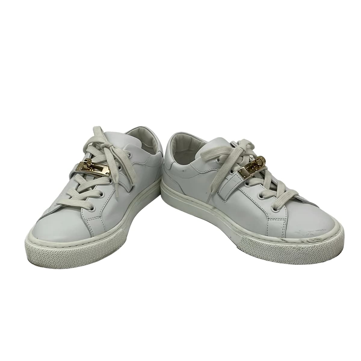 Pair of white low-top lace-up shoes shown from the side on a plain background.