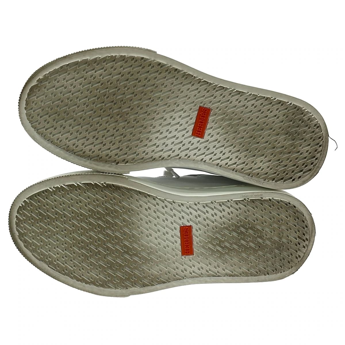 Pair of white low-top lace-up shoes shown from the side on a plain background.