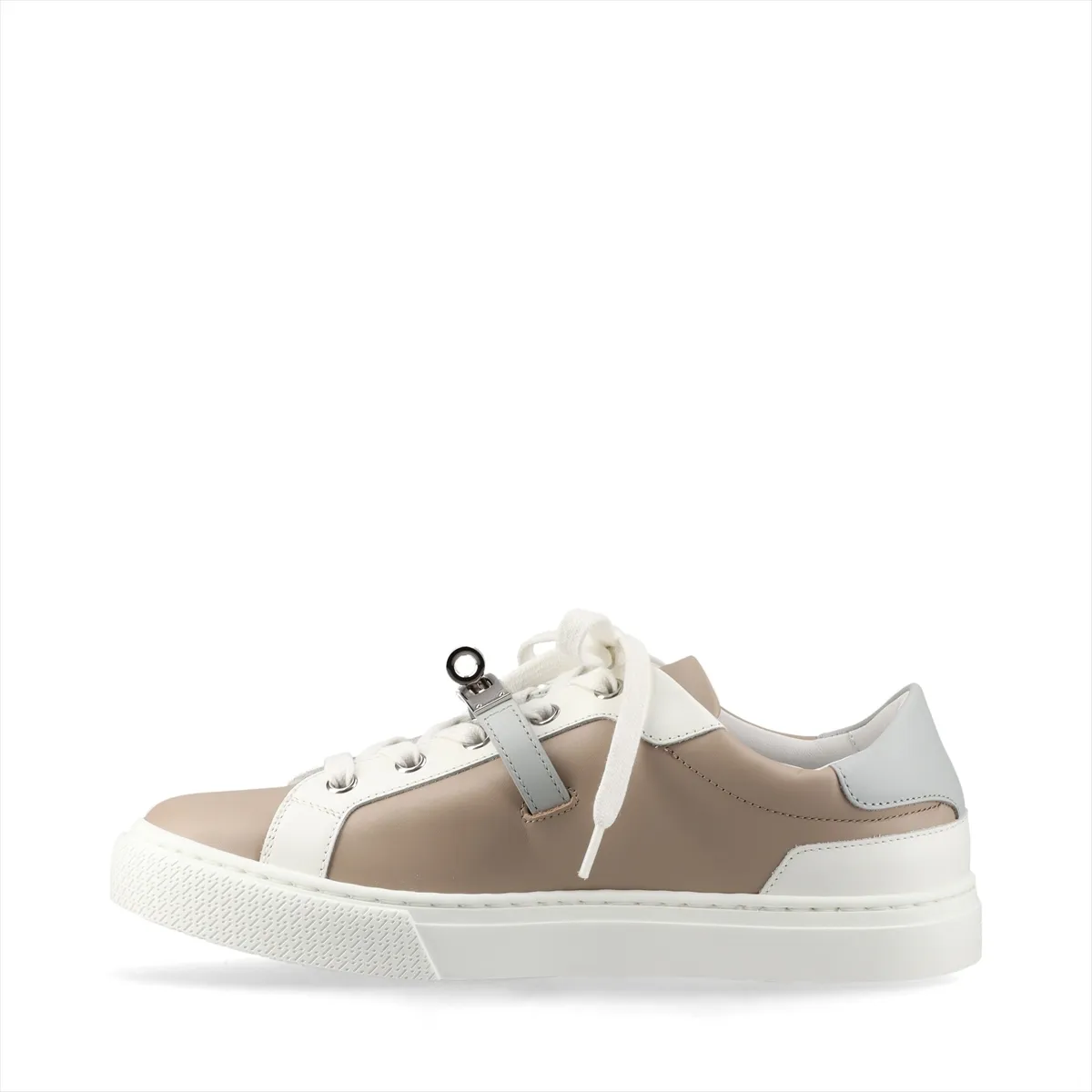 Beige and grey leather low-top sneakers with a metal buckle detail on the side.