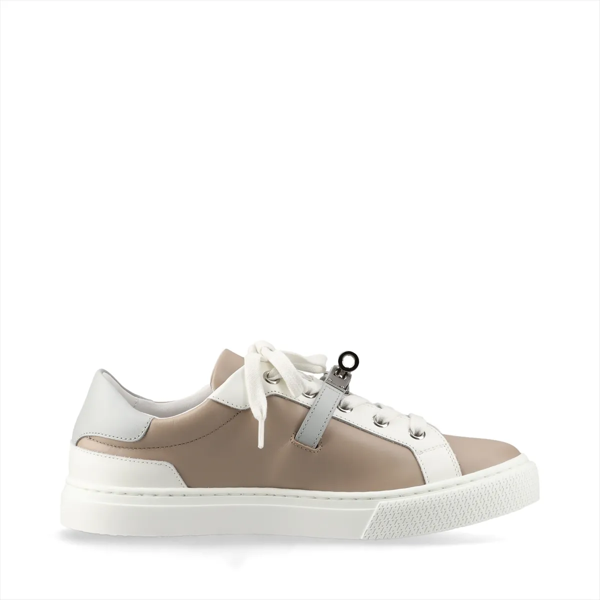 Beige and grey leather low-top sneakers with a metal buckle detail on the side.