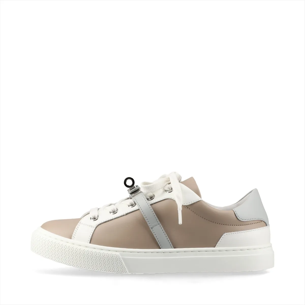 Beige and grey leather low-top sneakers with a metal buckle detail on the side.