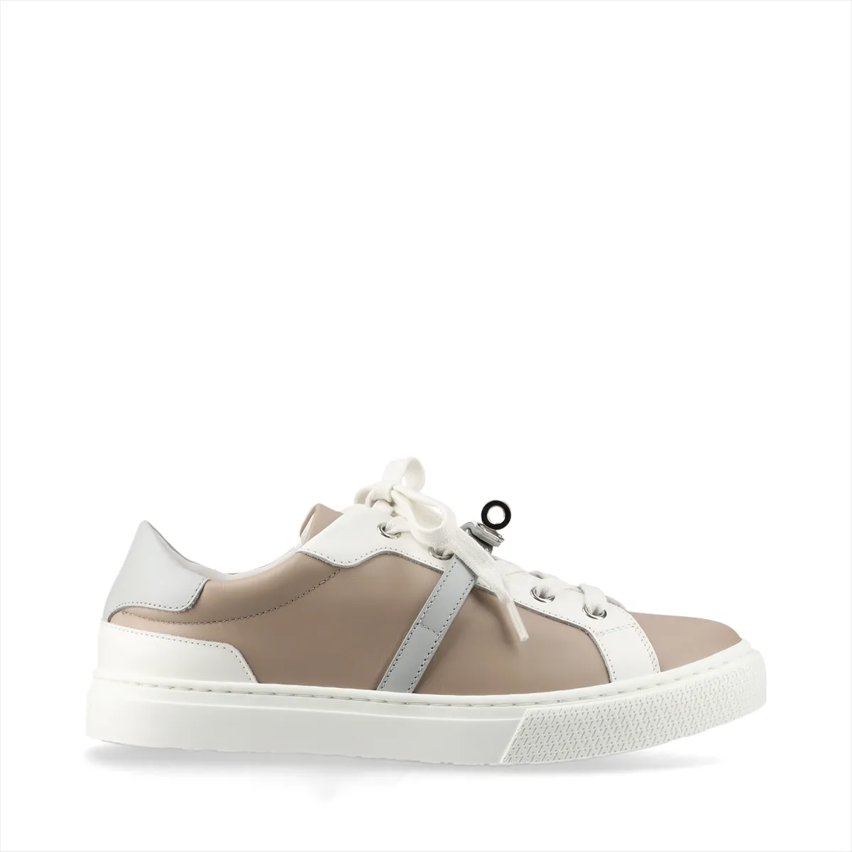 Beige and grey leather low-top sneakers with a metal buckle detail on the side.