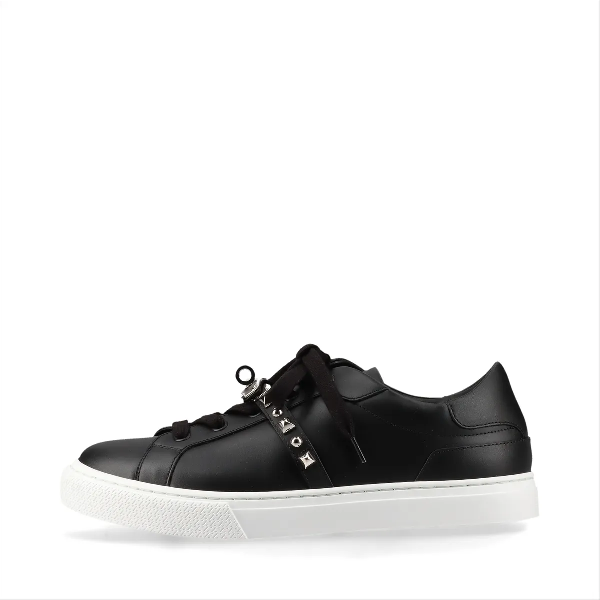 Black leather sneakers with metal buckle hardware and studded detailing