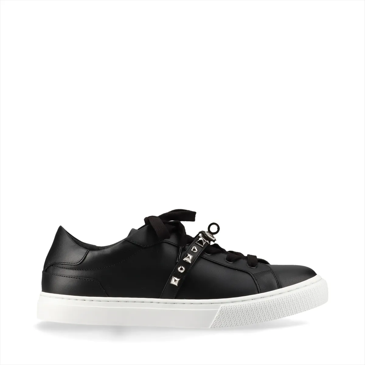 Black leather sneakers with metal buckle hardware and studded detailing