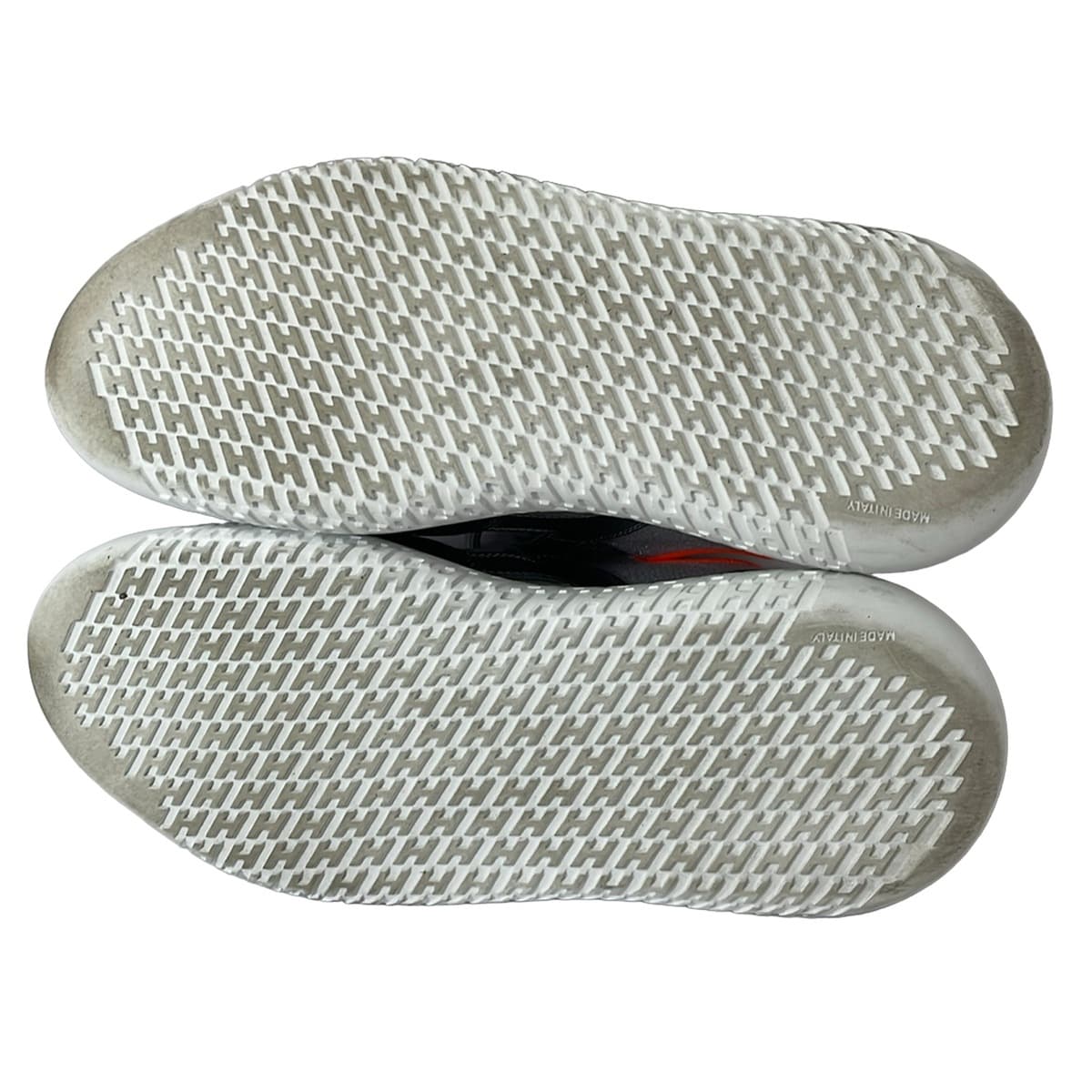Grey low-top trainers with silver side panelling and white soles.