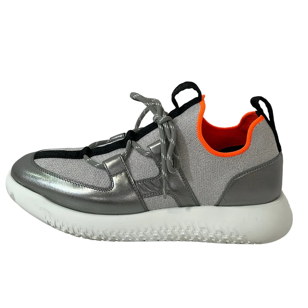 Grey low-top trainers with silver side panelling and white soles.