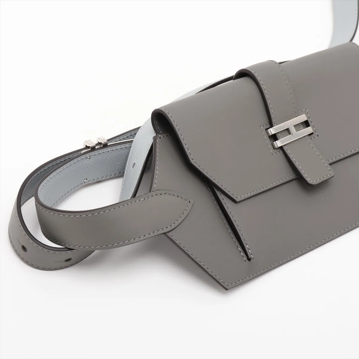 Two-tone grey and pale blue leather bag with a front flap pocket and silver fittings.