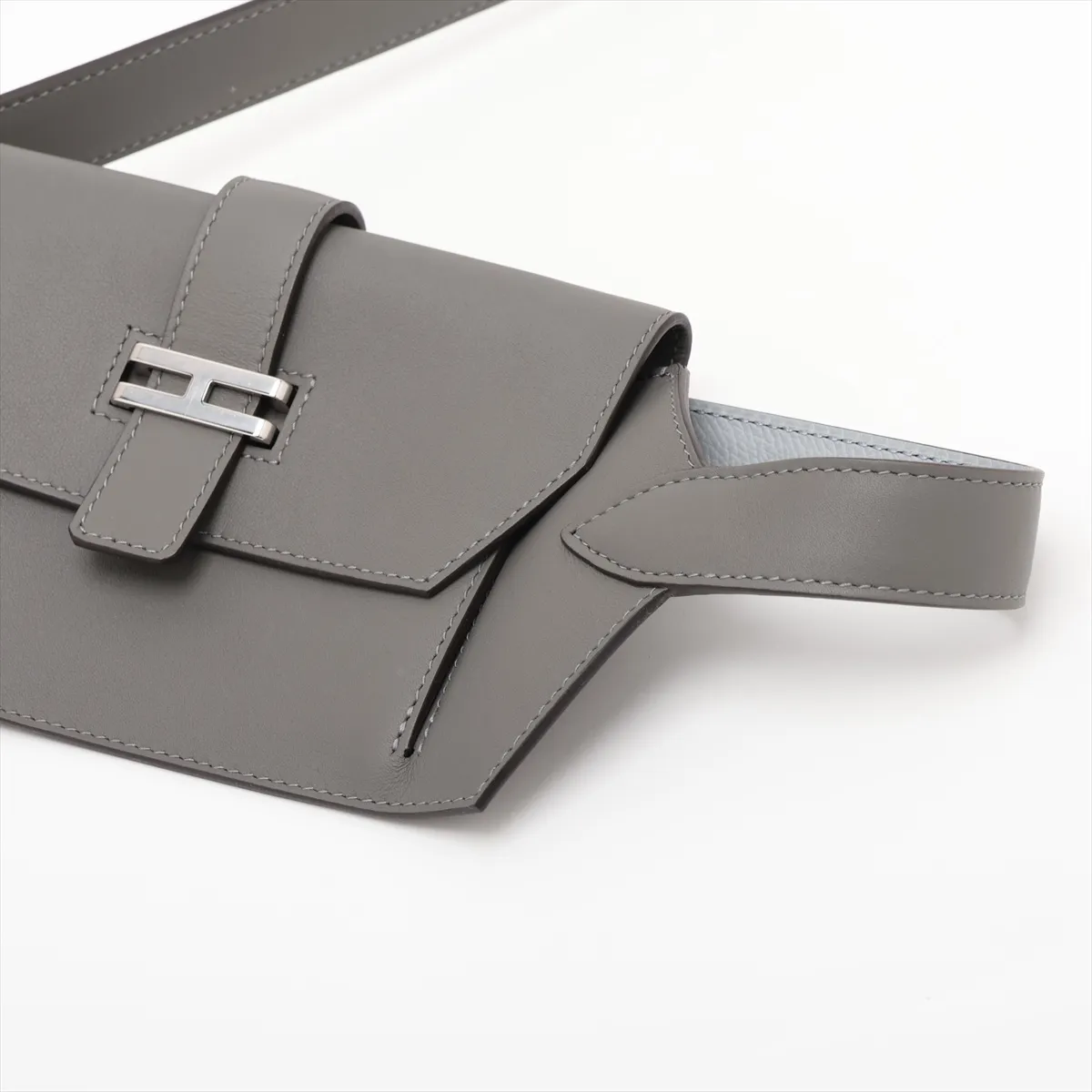 Two-tone grey and pale blue leather bag with a front flap pocket and silver fittings.