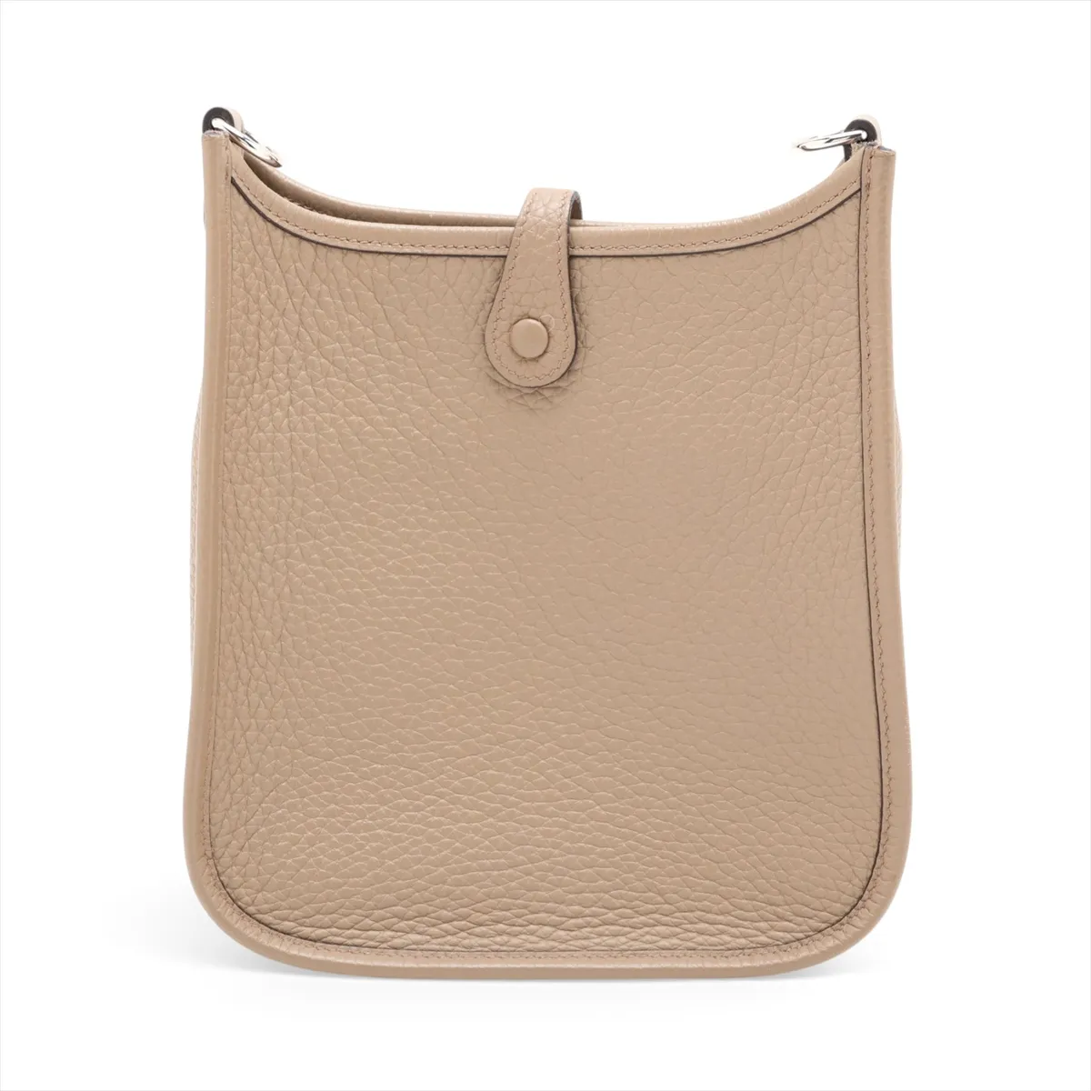 Small beige leather shoulder bag with perforated H on the front and a long woven strap.