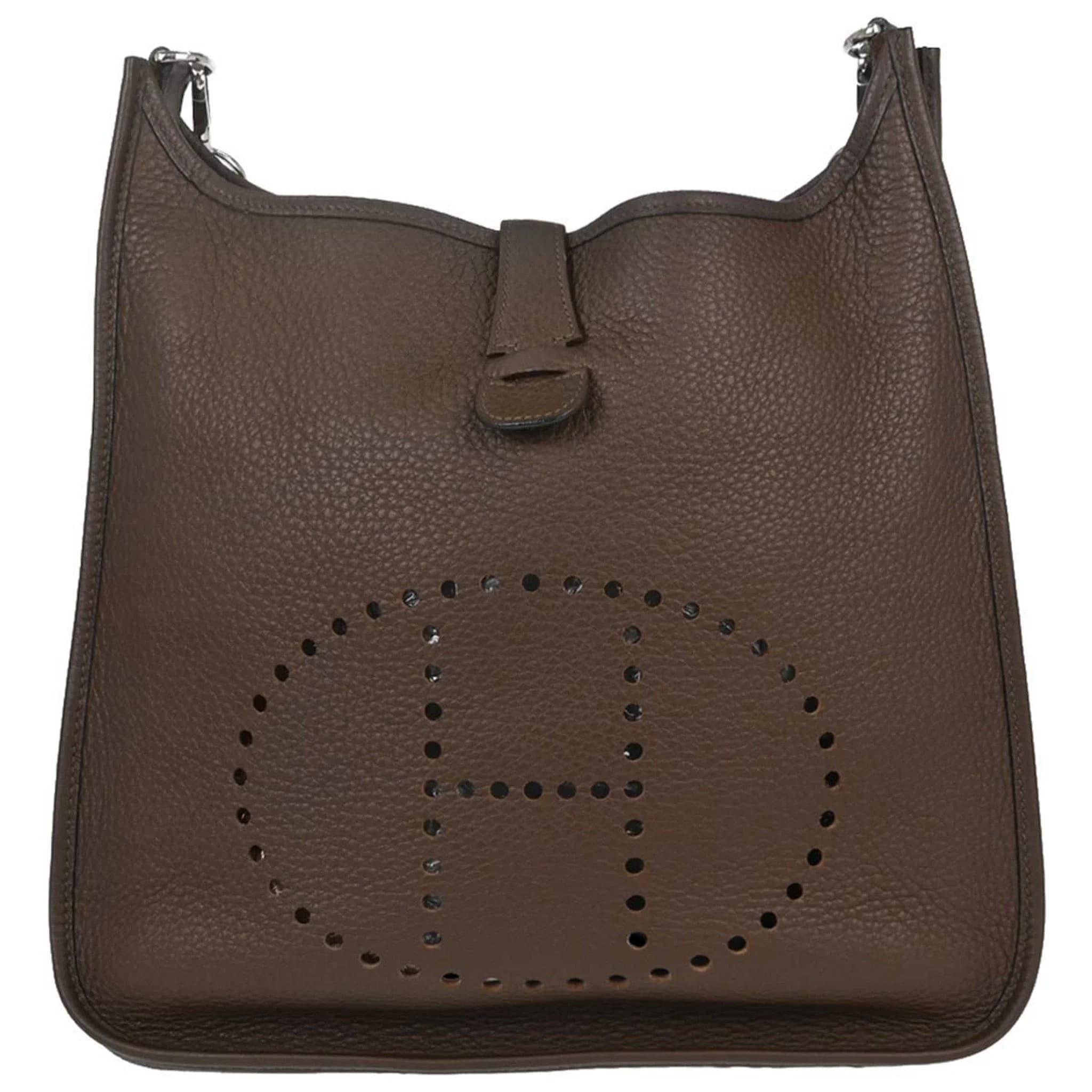 Brown grained leather shoulder bag with perforated design on the front and a wide strap