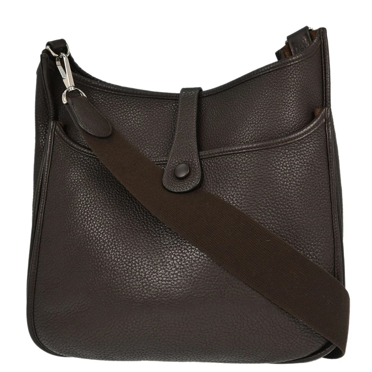 Brown leather shoulder bag with perforated logo front panel and long flat strap.