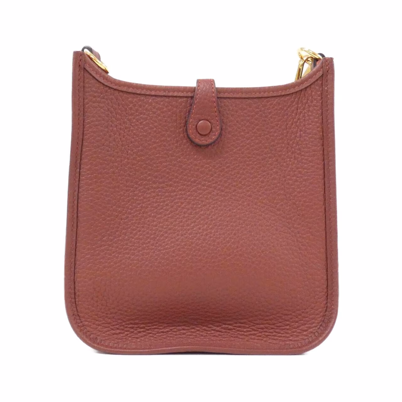 Small leather shoulder bag with perforated H on the front and woven strap.