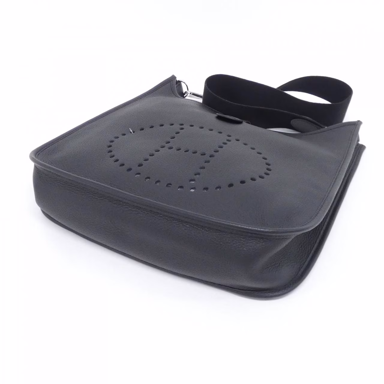Large leather shoulder bag with perforated H cut-out on the front and a long adjustable strap