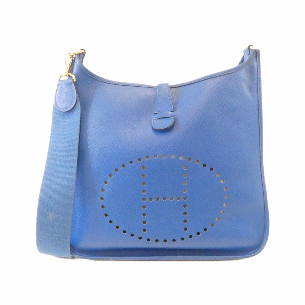 Leather shoulder bag with perforated H motif on the front and a long adjustable strap.