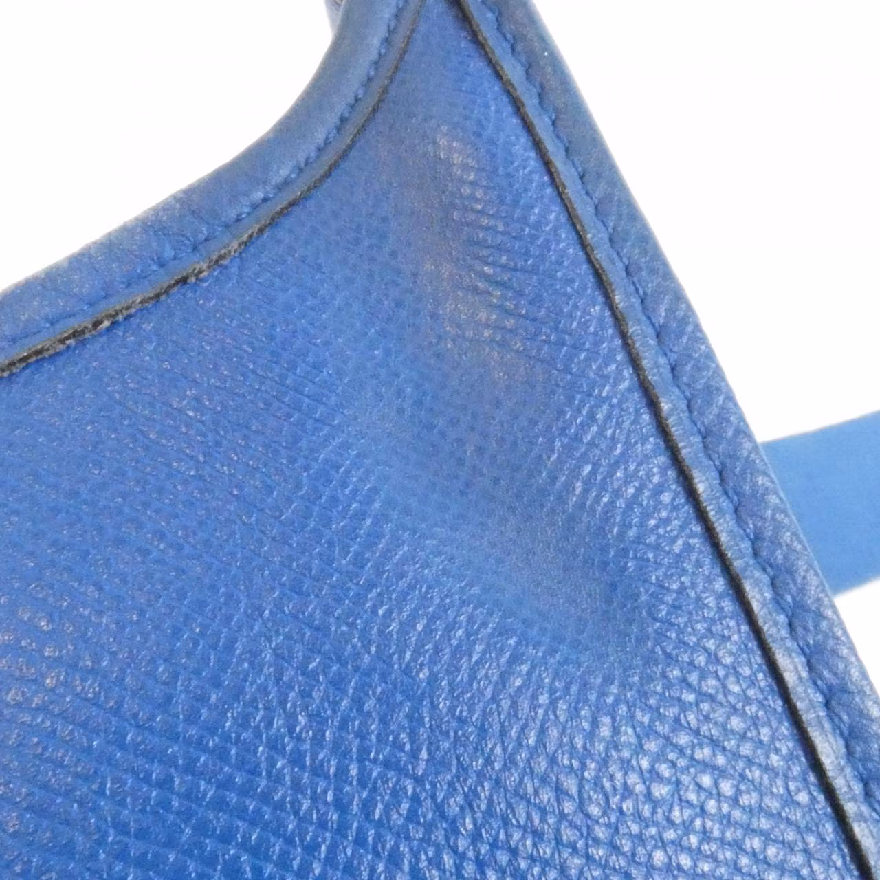Leather shoulder bag with perforated H motif on the front and a long adjustable strap.