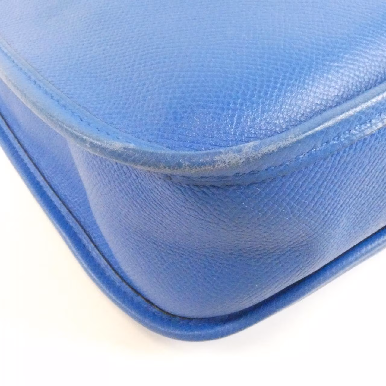 Leather shoulder bag with perforated H motif on the front and a long adjustable strap.
