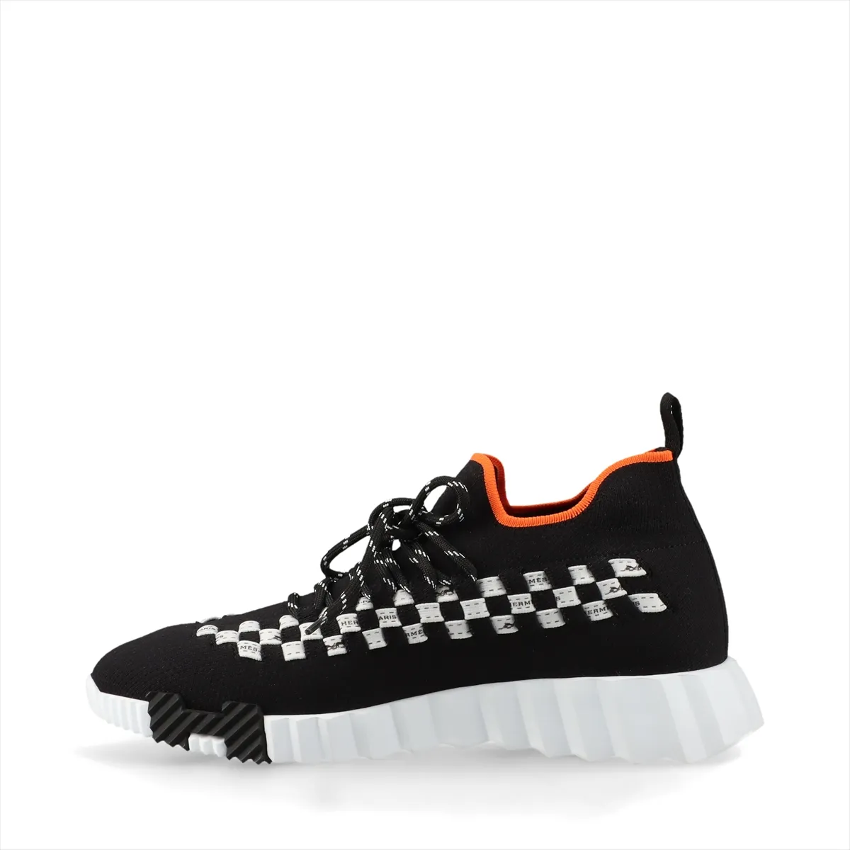 Black knit sneaker with white sole and white detailing at the heel.