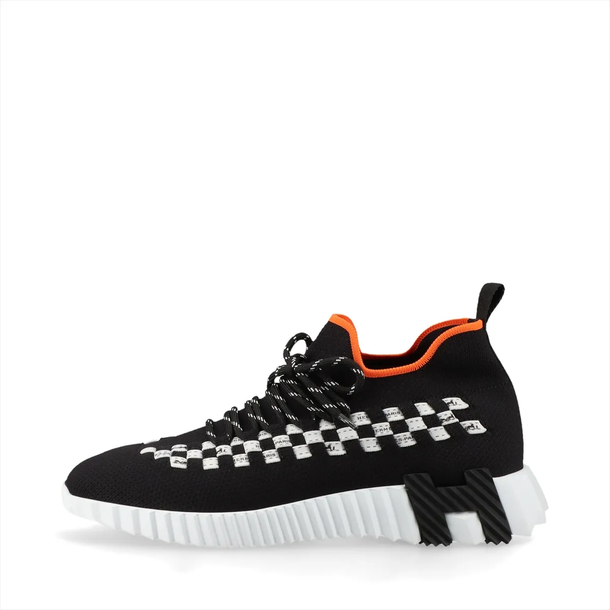 Black knit sneaker with white sole and white detailing at the heel.